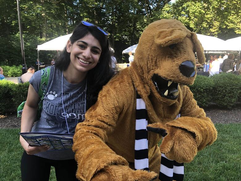 Student and Nittany Lion smiling for photo